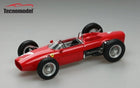 Red diecast model F1 car with exposed wheels and Tecnomodel logo on gray background