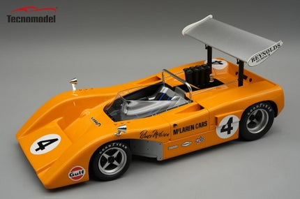 Orange diecast McLaren race car model with large rear wing, number 4, and detailed decals.