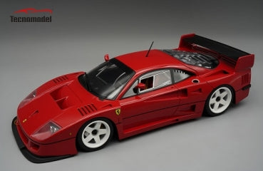 Red diecast model car with racing details and rear wing on display, viewed from above