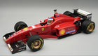 1:18 scale red Ferrari Formula 1 diecast model car with sponsor decals and detailed cockpit