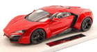 Red diecast sports car model with black wheels, displayed on a white base.