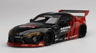 Diecast 1:18 scale black and red Toyota Supra model car with racing decals and rear wing