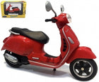 Red diecast Vespa scooter model with packaging, 1:18 scale collectible toy.