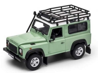 Green diecast model Land Rover Defender 1:24 scale with roof rack, detailed exterior.