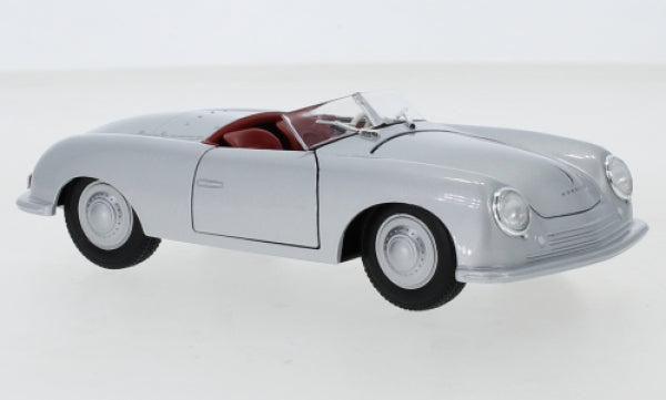 Silver diecast model classic convertible car with red interior on white background