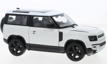 White diecast Land Rover Defender 1:24 scale model car with black wheels and roof details