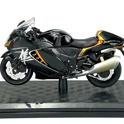 1:18 scale black Suzuki motorcycle model with gold accents on display stand