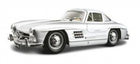 Silver classic diecast model car in 1:18 scale with detailed features against white background