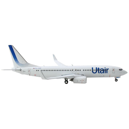 https://cdn.shopify.com/s/files/1/0504/9925/6496/products/boeing-737-800-commercial-aircraft-utair-white-with-blue-tail-stripes-1400-diecast-model-airplane-by-geminijets-929263.jpg?v=1748420537