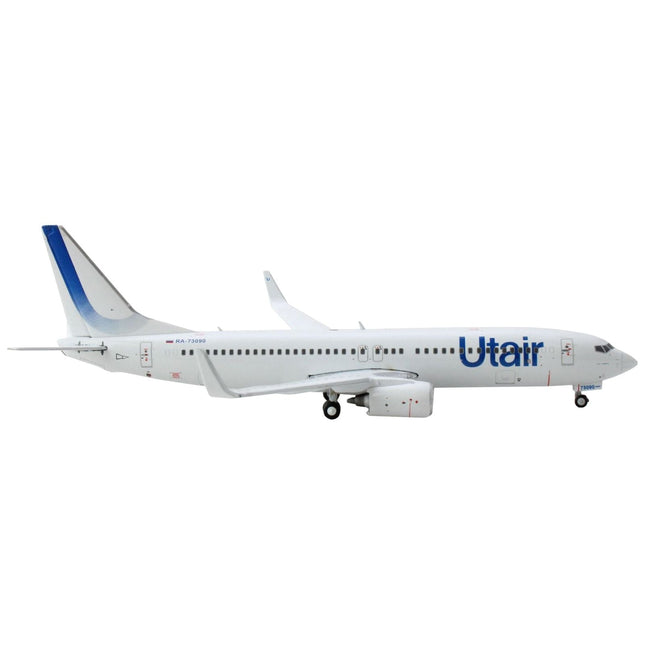 https://cdn.shopify.com/s/files/1/0504/9925/6496/products/boeing-737-800-commercial-aircraft-utair-white-with-blue-tail-stripes-1400-diecast-model-airplane-by-geminijets-929263.jpg?v=1748420537