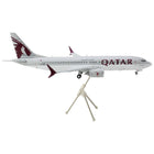 https://cdn.shopify.com/s/files/1/0504/9925/6496/products/boeing-737-max-8-commercial-aircraft-qatar-airways-gray-and-white-with-tail-graphics-gemini-200-series-1200-diecast-model-airplane-by-geminijets-929356.jpg?v=1748420539