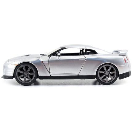 https://cdn.shopify.com/s/files/1/0504/9925/6496/files/brians-nissan-gt-r-r35-silver-metallic-fast-furious-movie-132-diecast-model-car-by-jada-456640.jpg?v=1748419126