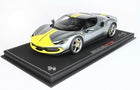 1:18 scale gray Ferrari 296 GTS diecast model car with yellow racing stripes on display base