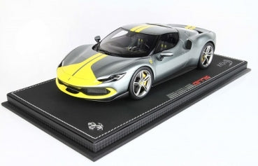 1:18 scale gray Ferrari 296 GTS model car with yellow racing stripes on display base