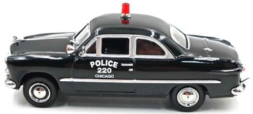 1:43 scale 1949 black Ford Custom diecast police car model with red roof light, rear view