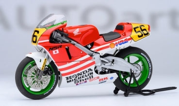 Red and white 1:12 scale Honda NSR500 diecast motorcycle model with green wheels