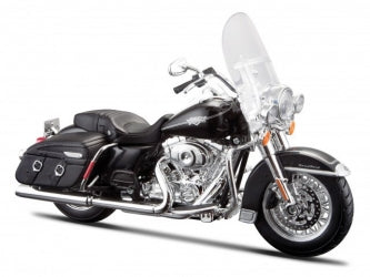 Black diecast model motorcycle with windshield and saddlebags on white background