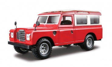 Red diecast model Land Rover classic SUV in 1:18 scale on white background