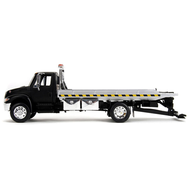 https://cdn.shopify.com/s/files/1/0504/9925/6496/files/international-durastar-4400-flatbed-tow-truck-matt-black-124-diecast-model-car-by-jada-516474.jpg?v=1748405109
