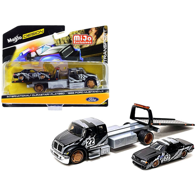 https://cdn.shopify.com/s/files/1/0504/9925/6496/files/international-durastar-flatbed-truck-22-and-1988-ford-mustang-lx-22-matt-black-with-gray-graphics-toyo-tires-elite-transport-series-164-diecast-models-by-maisto-330682.jpg?v=1748418495