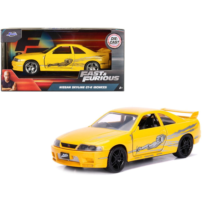 https://cdn.shopify.com/s/files/1/0504/9925/6496/files/leons-nissan-skyline-gt-r-bcnr33-yellow-metallic-with-graphics-fast-furious-series-132-diecast-model-car-by-jada-260403.jpg?v=1748419006