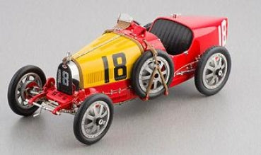 1:18 scale diecast vintage race car model in yellow and red with number 18 and exposed wheels