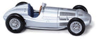 Silver vintage diecast model race car with detailed wheels and blue interior, 1:18 scale.