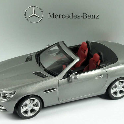 Minichamps Mercedes-Benz SLK R172 2011 Palladium Silver Metallic 1:18 scale model car displayed in front of a Mercedes-Benz backdrop