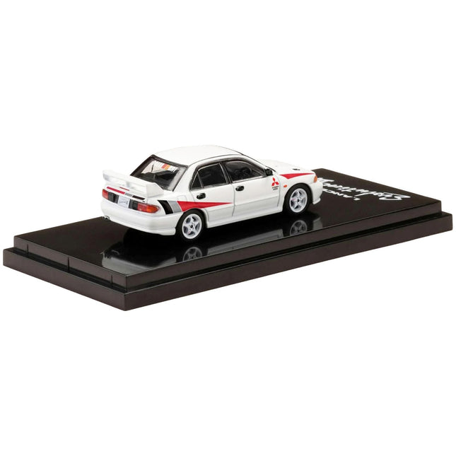 https://cdn.shopify.com/s/files/1/0504/9925/6496/files/mitsubishi-lancer-rs-evolution-iii-rhd-right-hand-drive-scortia-white-with-red-rally-stripes-164-diecast-model-car-by-hobby-japan-161059.jpg?v=1748404191
