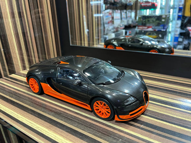 AutoArt Bugatti Veyron 16.4 Super Sport Black Carbon/Orange 1:18 Diecast Model Car - studio product photo of the scale model