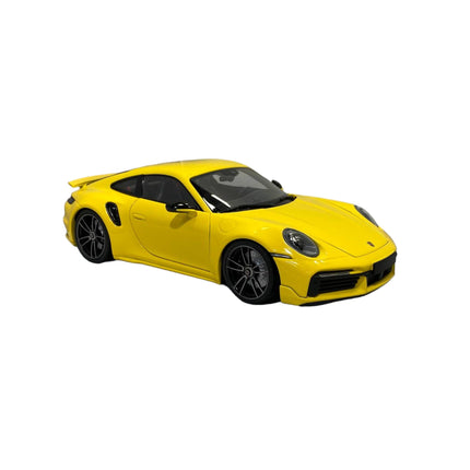 Minichamps Porsche 911 (992) Turbo S Coupe Sport Design 1:18 Yellow 2021 - studio product photo of the scale model