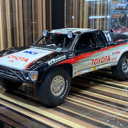 AutoArt Toyota Trophy Truck #11 White and Black 1:18 Diecast Model Truck - studio product photo of the scale model