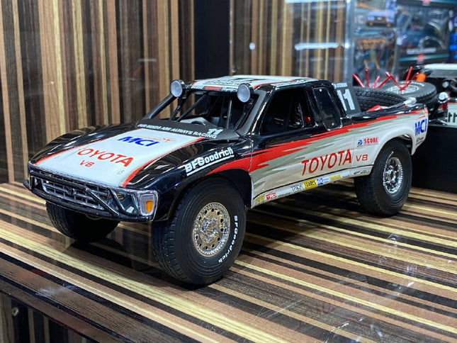 AutoArt Toyota Trophy Truck #11 White and Black 1:18 Diecast Model Truck - studio product photo of the scale model