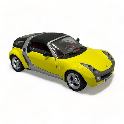 Bburago Smart Roadster Coupe 1/18 Diecast Model Car Yellow - studio product photo of the scale model