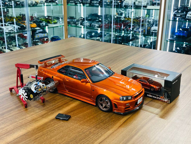MotorHelix Nissan Skyline GT-R R34 Z-Tune Nismo 1/18 Diecast Model Metallic Orange - studio product photo of the scale model