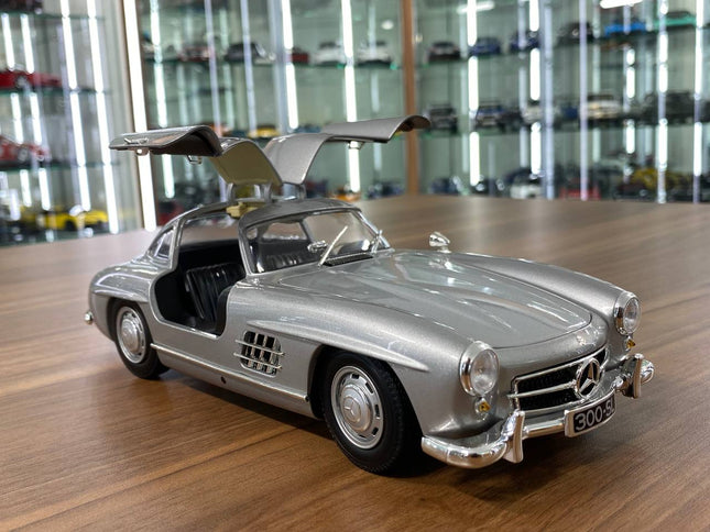 Minichamps Mercedes-Benz 300 SL 1955 1:18 Silver Diecast Model Car with Opening Doors - studio product photo of the scale mod