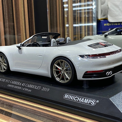 Minichamps 1:18 Porsche 911 Carrera 4S Cabriolet 2019 White Diecast Model - studio product photo of the scale model