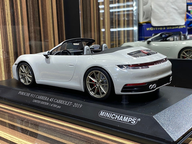 Minichamps 1:18 Porsche 911 Carrera 4S Cabriolet 2019 White Diecast Model - studio product photo of the scale model