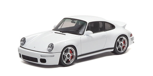 White 1:18 scale diecast model car with sporty design and silver rims, side view