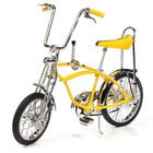 Yellow Schwinn Lemon Peeler bicycle model with chrome accents and banana seat, front view