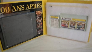 Renault diecast model car display set in box with illustrated garage background, yellow accents