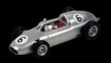 Silver vintage Formula 1 diecast model race car with number 6 and red interior on black background